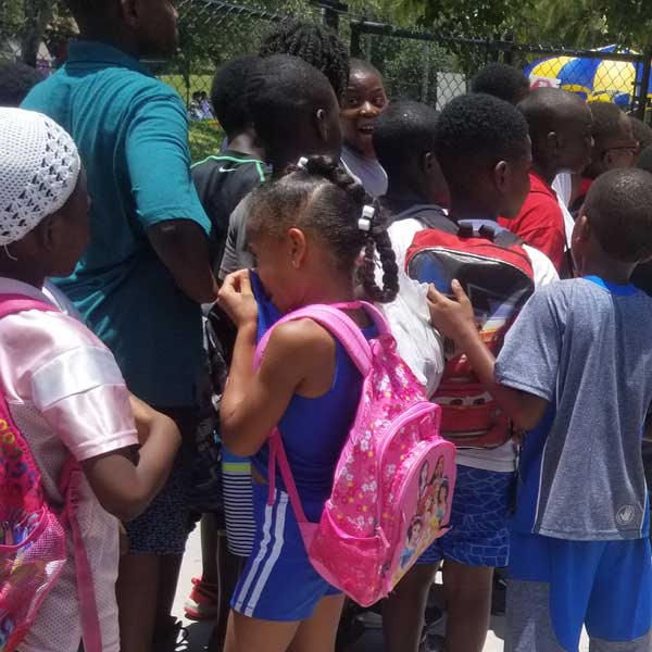 Kids with backpacks at summer camp
